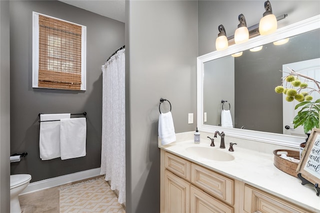 bathroom featuring tile patterned floors, vanity, and toilet