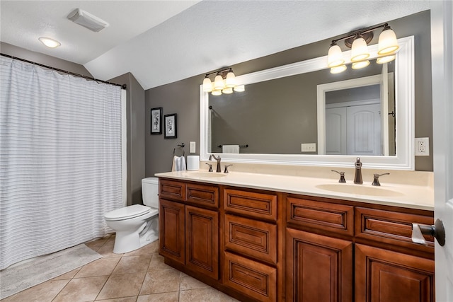 bathroom featuring vanity, lofted ceiling, a textured ceiling, tile patterned floors, and toilet