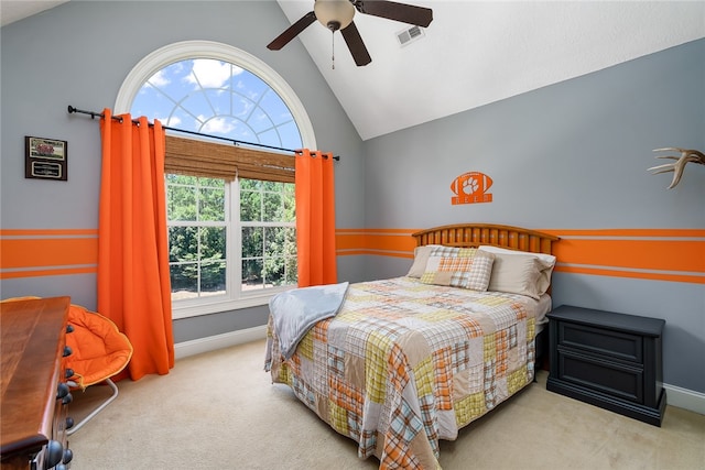 bedroom with vaulted ceiling, ceiling fan, and light colored carpet