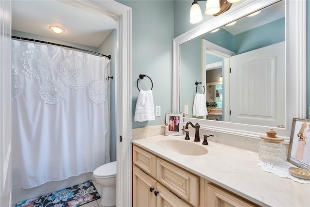 bathroom with tile patterned floors, vanity, and toilet