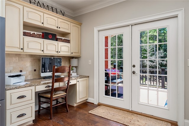 interior space featuring french doors, built in desk, dark hardwood / wood-style flooring, and crown molding