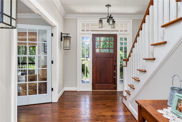 entrance foyer featuring a notable chandelier, crown molding, and dark hardwood / wood-style flooring