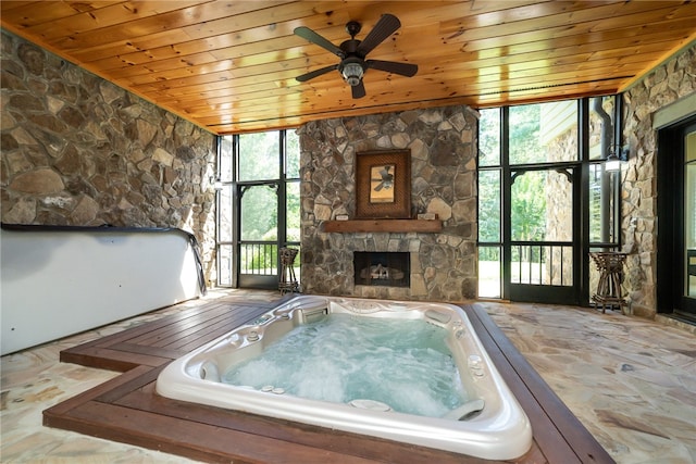 misc room with a hot tub, wooden ceiling, and a healthy amount of sunlight