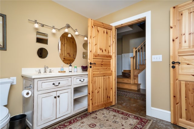 bathroom featuring vanity, toilet, and concrete floors