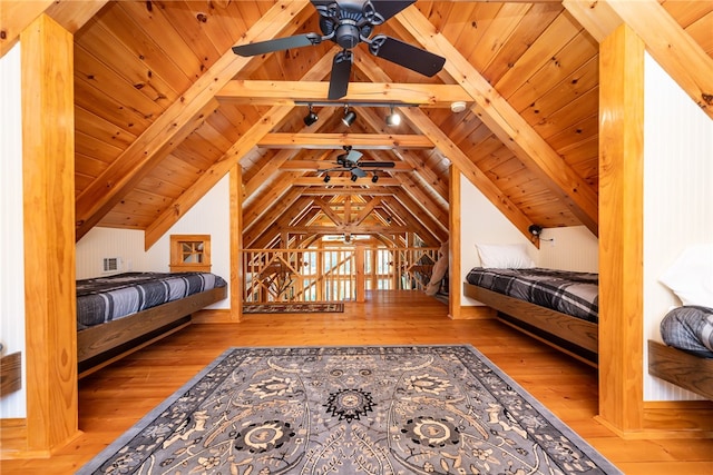 unfurnished bedroom featuring wood-type flooring, vaulted ceiling with beams, wooden ceiling, and ceiling fan