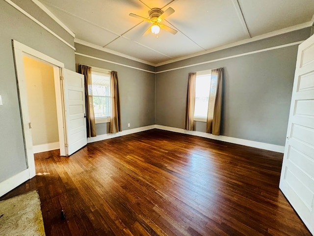 unfurnished bedroom featuring ornamental molding, multiple windows, dark hardwood / wood-style floors, and ceiling fan