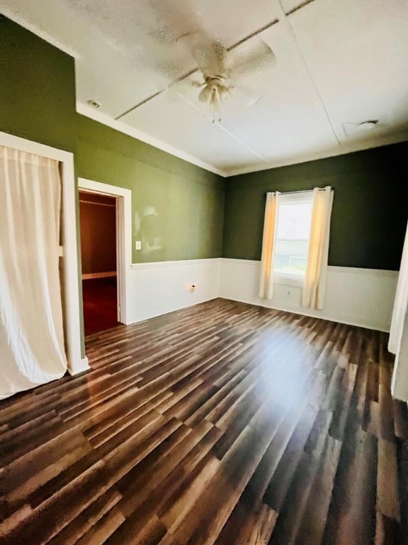 spare room featuring ceiling fan and dark wood-type flooring