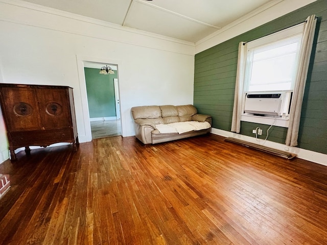 unfurnished room featuring cooling unit, wood walls, and hardwood / wood-style floors