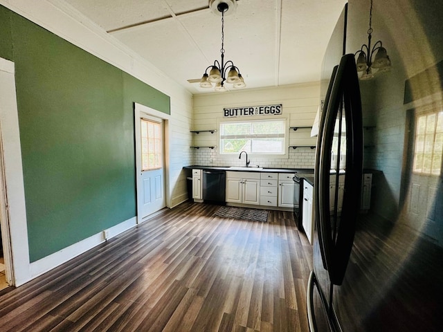 kitchen featuring dark hardwood / wood-style floors, white cabinetry, decorative backsplash, black appliances, and decorative light fixtures