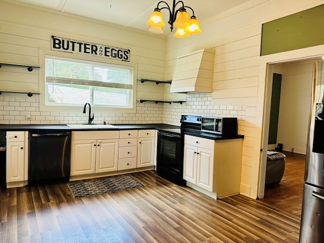 kitchen featuring black appliances, decorative backsplash, dark hardwood / wood-style floors, and wood walls