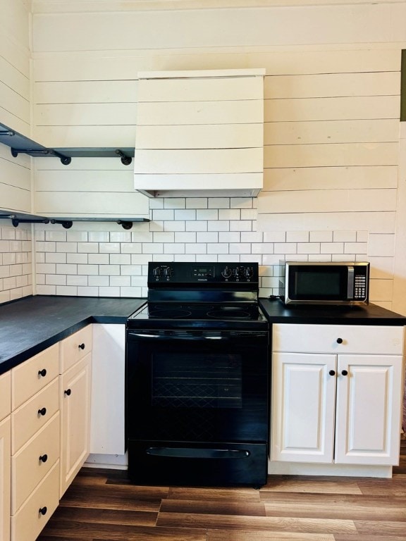 kitchen featuring white cabinets, hardwood / wood-style flooring, electric range, and tasteful backsplash