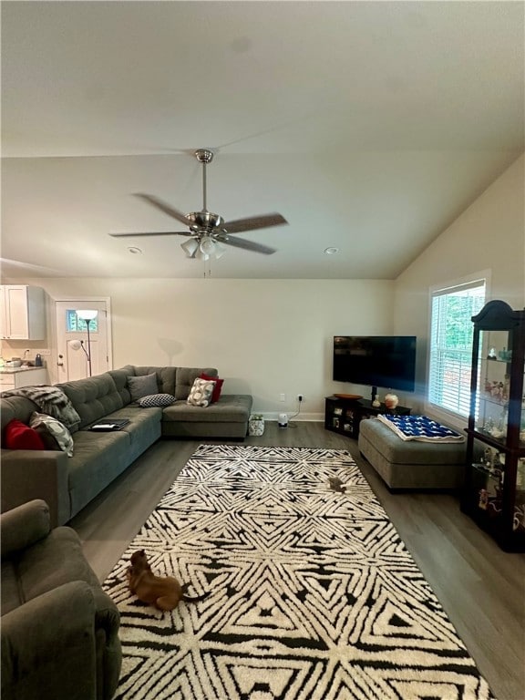 living room with wood-type flooring, vaulted ceiling, and ceiling fan