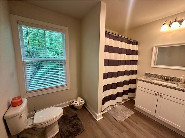 bathroom with walk in shower, vanity, toilet, and hardwood / wood-style flooring