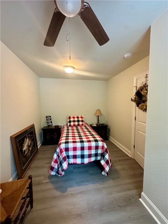 bedroom with hardwood / wood-style floors and ceiling fan