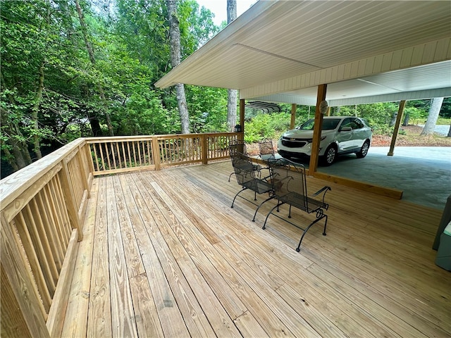 wooden deck featuring a carport