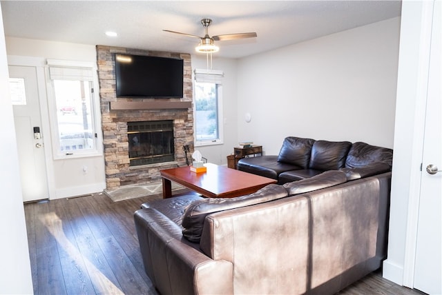 living room featuring a fireplace, dark hardwood / wood-style floors, and ceiling fan