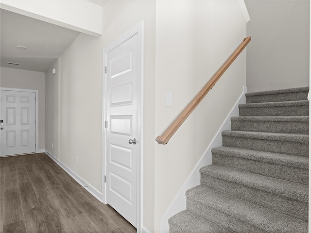 staircase featuring wood-type flooring