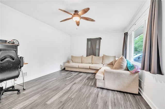 living room featuring crown molding, hardwood / wood-style floors, and ceiling fan