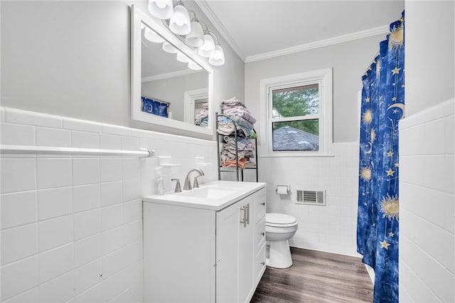 bathroom featuring vanity, toilet, tile walls, crown molding, and hardwood / wood-style floors