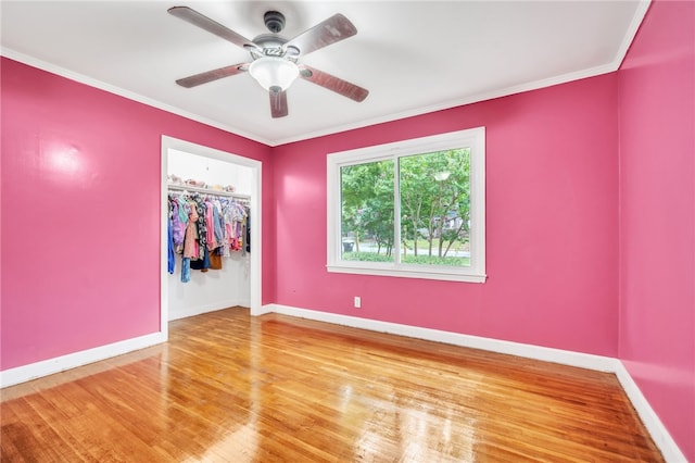 spare room with ceiling fan, crown molding, and hardwood / wood-style floors