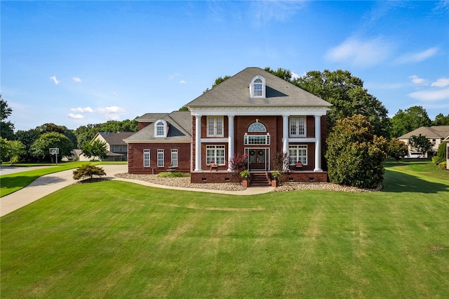 greek revival house featuring a front yard