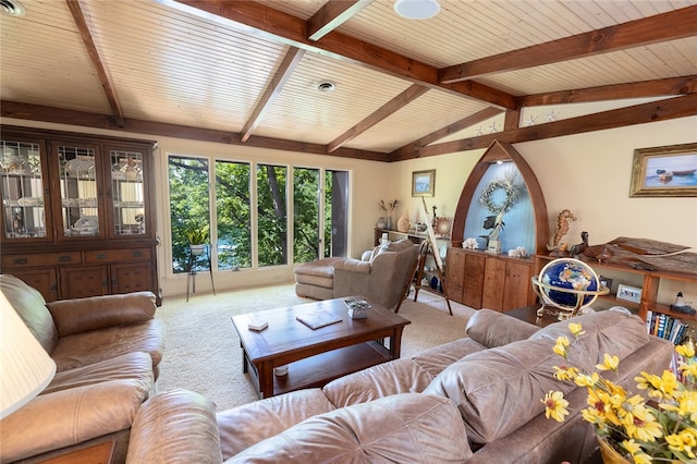 carpeted living room featuring lofted ceiling with beams