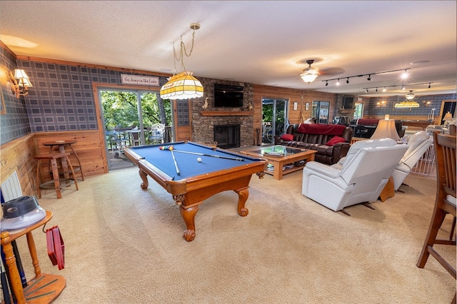 recreation room with pool table, carpet flooring, a stone fireplace, and ceiling fan