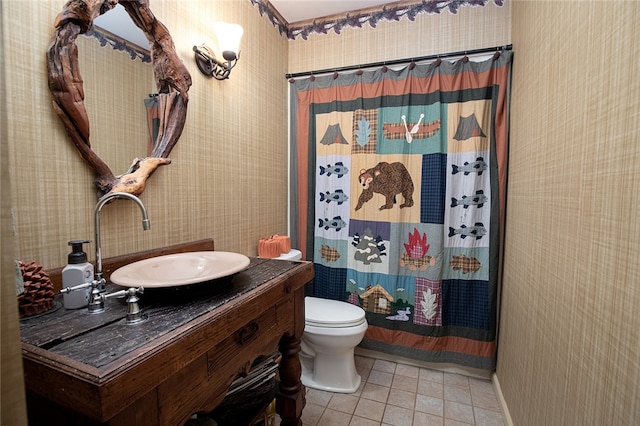 bathroom with a shower with shower curtain, tile patterned floors, vanity, and toilet