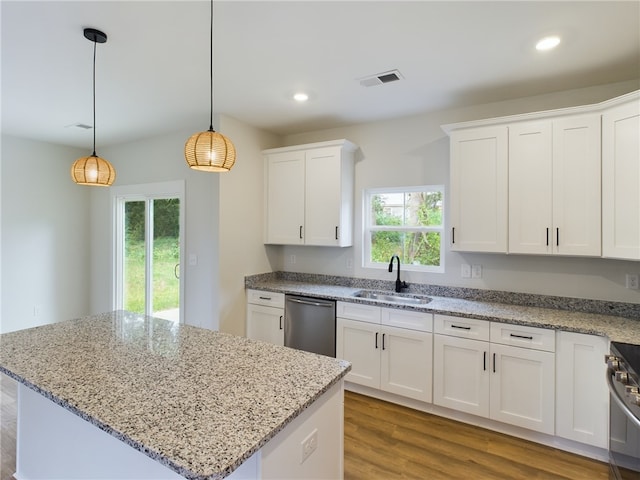 kitchen with stainless steel appliances, white cabinetry, and sink