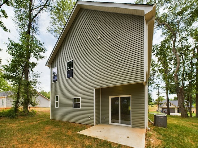 back of house featuring a patio, central air condition unit, and a yard