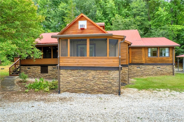 log home featuring a sunroom