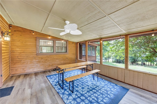 unfurnished sunroom featuring vaulted ceiling, ceiling fan, and a wealth of natural light