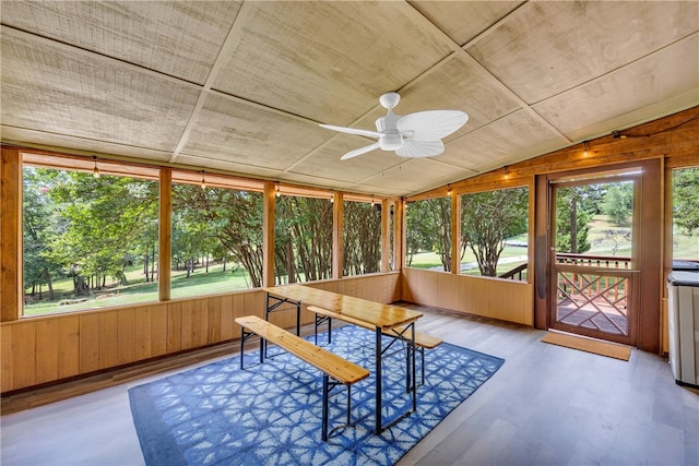 sunroom with ceiling fan, lofted ceiling, and plenty of natural light