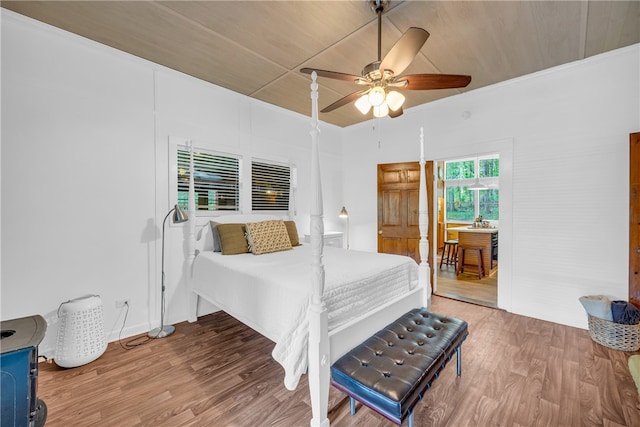 bedroom featuring wood-type flooring, ceiling fan, wooden ceiling, and crown molding