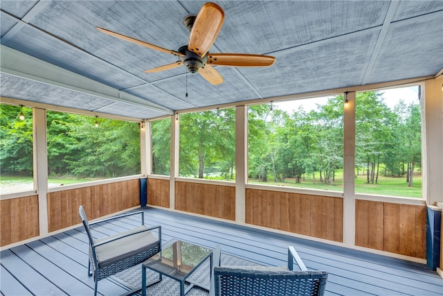 unfurnished sunroom featuring a wealth of natural light and ceiling fan