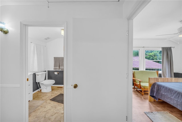 bathroom featuring ceiling fan, hardwood / wood-style flooring, and toilet