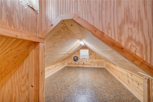 additional living space with wooden walls and lofted ceiling