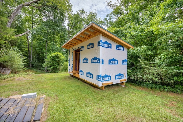 view of outbuilding featuring a lawn