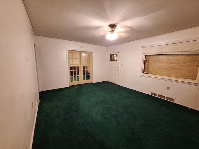 unfurnished room with ceiling fan, dark carpet, and french doors