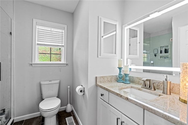 bathroom with toilet, tile patterned flooring, a shower with door, and vanity