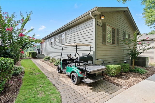 view of side of property featuring central air condition unit