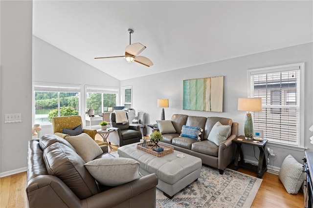 living room with ceiling fan, light wood-type flooring, and vaulted ceiling