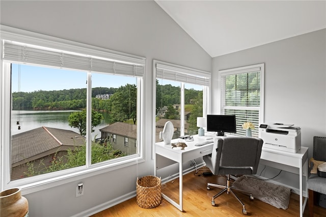 office featuring hardwood / wood-style flooring, a water view, and vaulted ceiling