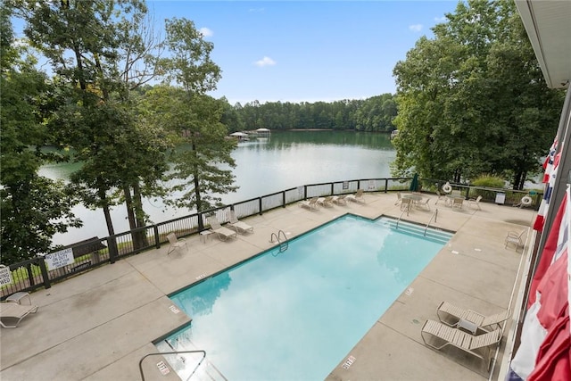 view of pool with a water view and a patio