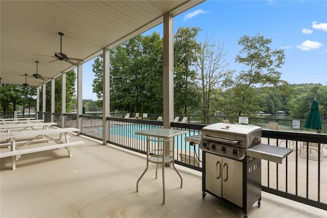 view of patio with ceiling fan, a community pool, and grilling area