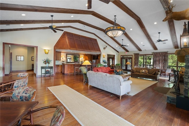 living room featuring beam ceiling, hardwood / wood-style flooring, and high vaulted ceiling