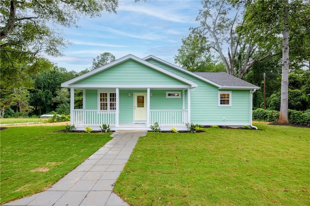 view of front of home with a porch and a front lawn