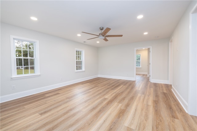 unfurnished room with ceiling fan, light hardwood / wood-style floors, and a wealth of natural light