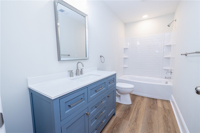 full bathroom with hardwood / wood-style floors, vanity, toilet, and bathtub / shower combination