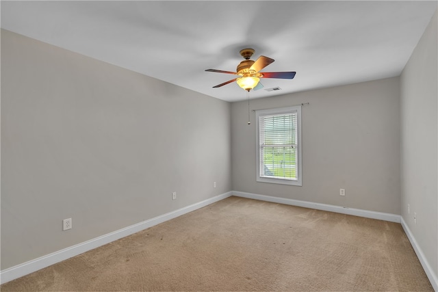 empty room featuring ceiling fan and light colored carpet